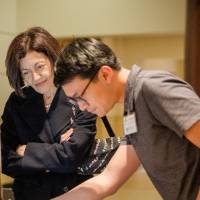 Randy Nguyen showing his research to the Provost